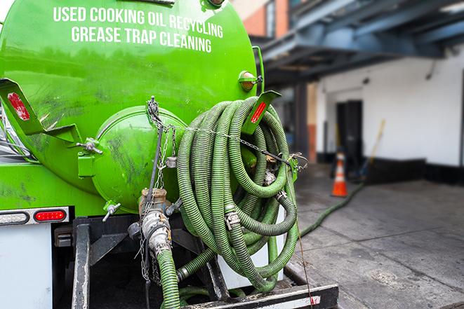 grease trap pumping truck in action in North Hills CA